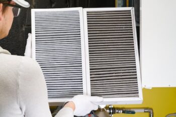 Replacing Filter In The Central Ventilation System. Hvac Filter Replacing Home Central Air System