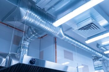 Ventilation System On Ceiling Of Industrial Room. Air Purification System In Restaurant. Pipes From The Hood On Ceiling, Bottom View. Air Purification System In An Industrial Kitchen.